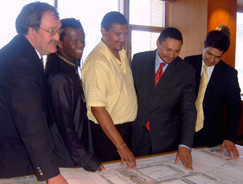 Officials and business leaders signing an agreement to boost development 