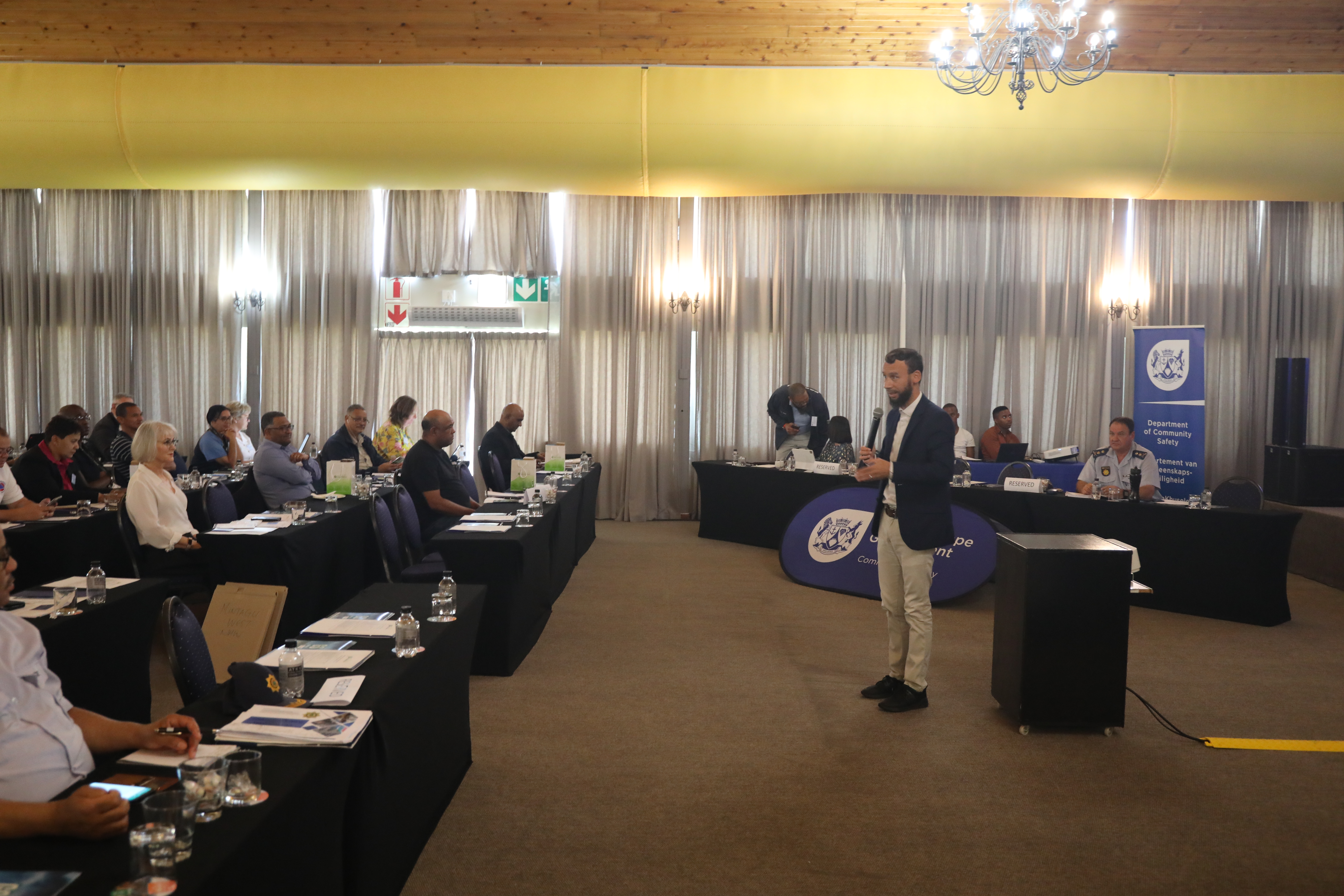 Minister for Police Oversight and Community Safety, Reagen Allen addresses the stakeholders at the Cape Winelands Rural Safety Summit held at Goudini Spa. 