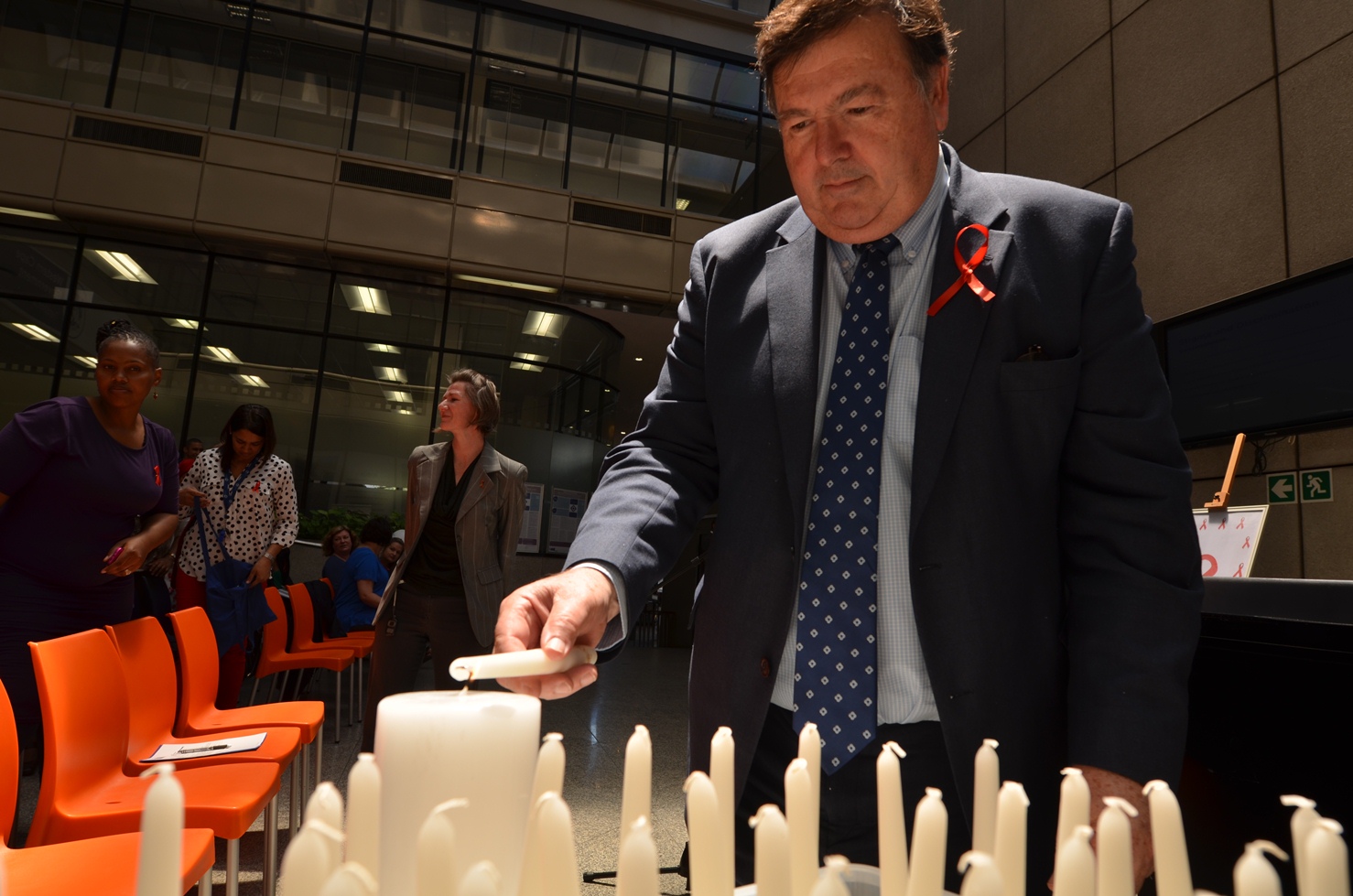 Minister Grant lights a candle to commemorate World AIDS Day on 1 December 2014.