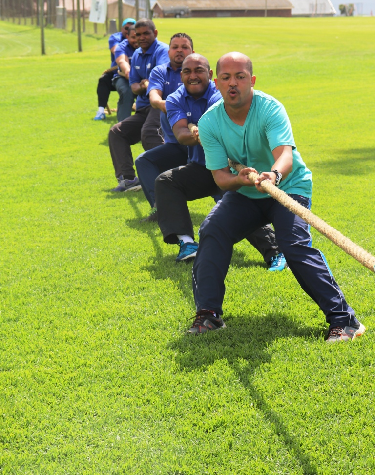 A team from the Department of Health holds on during a match of tug-of-war.