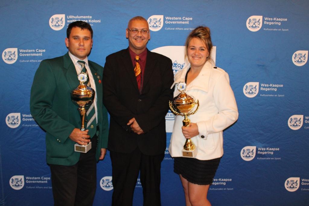 Advocate Lyndon Bouah, Chief Director of Sport at DCAS with the Sportsman and Sportswoman of the Year 2015, Ruehan van Romburgh and Annelie Stevens