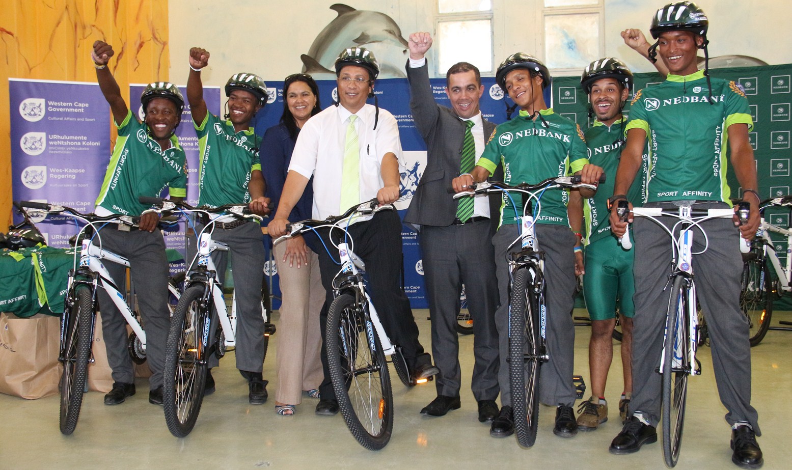 DCAS, Nedbank and Sports Trust staff pose with development cyclists.