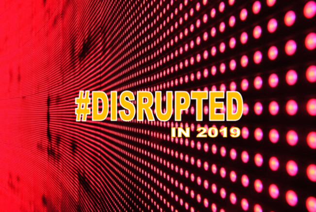 Word disrupted in 2019 on a blackground of red dots