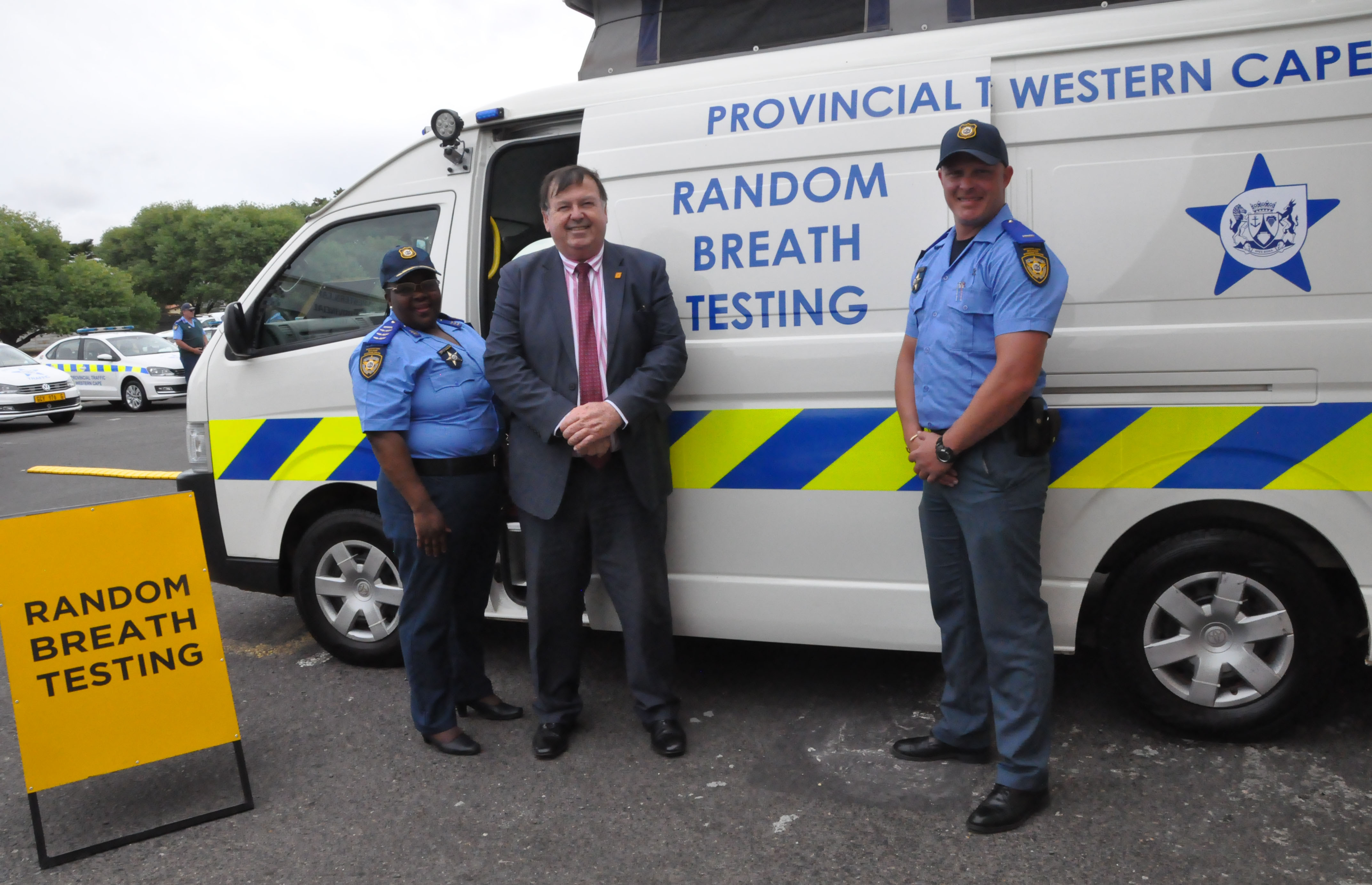 Minister Grant with provincial traffic officers and one of the new Mobile Alcohol Evidentiary Units at the launch.