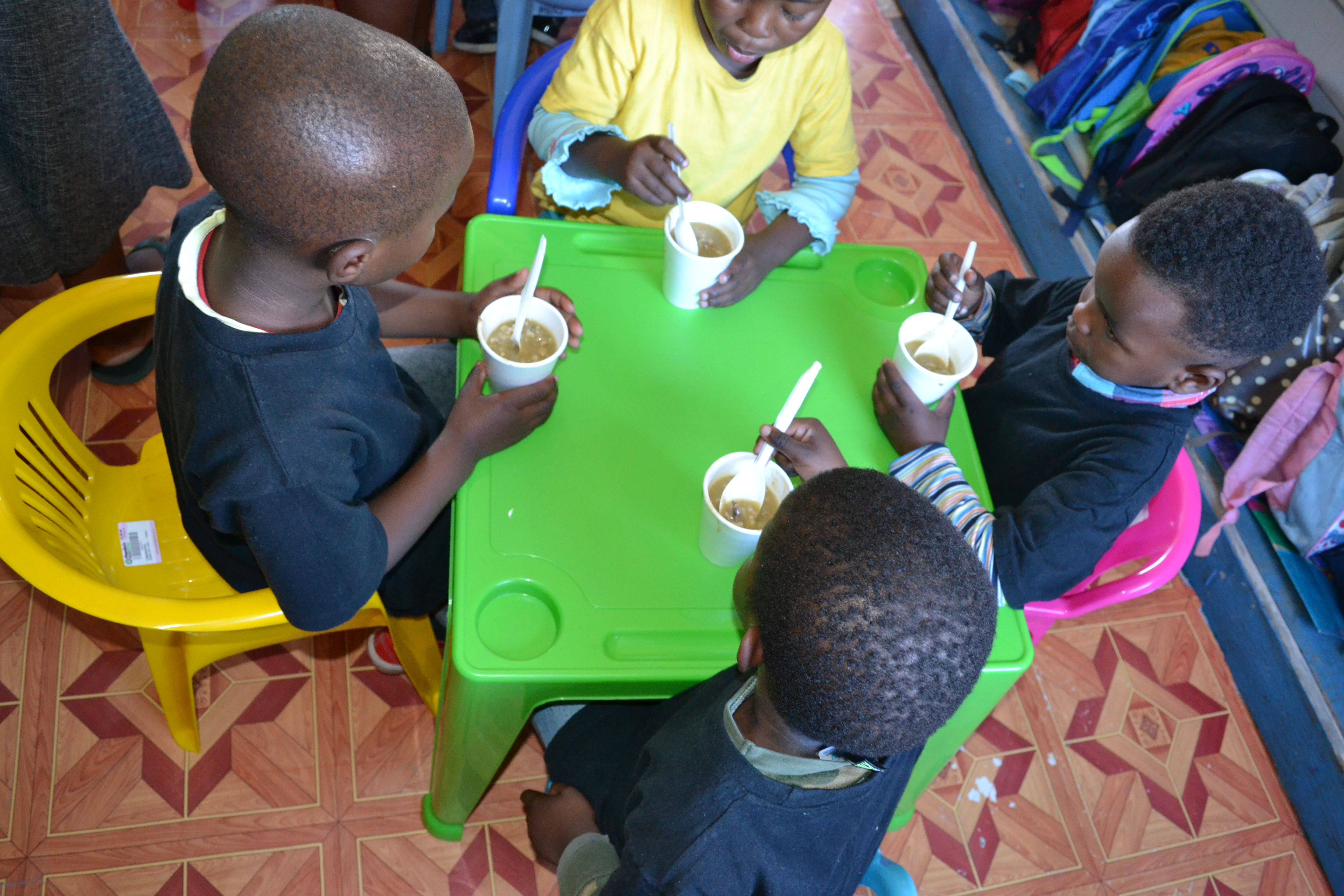 Children enjoying soup at their new table and chairs at the Lihle ECD Centre in George.