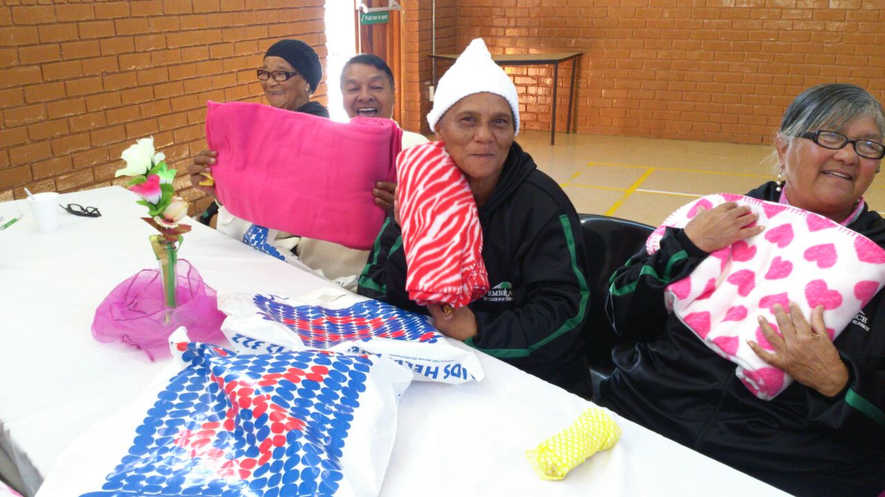 Members of the Embrace Senior Club receive blankets donated by staff of DSD