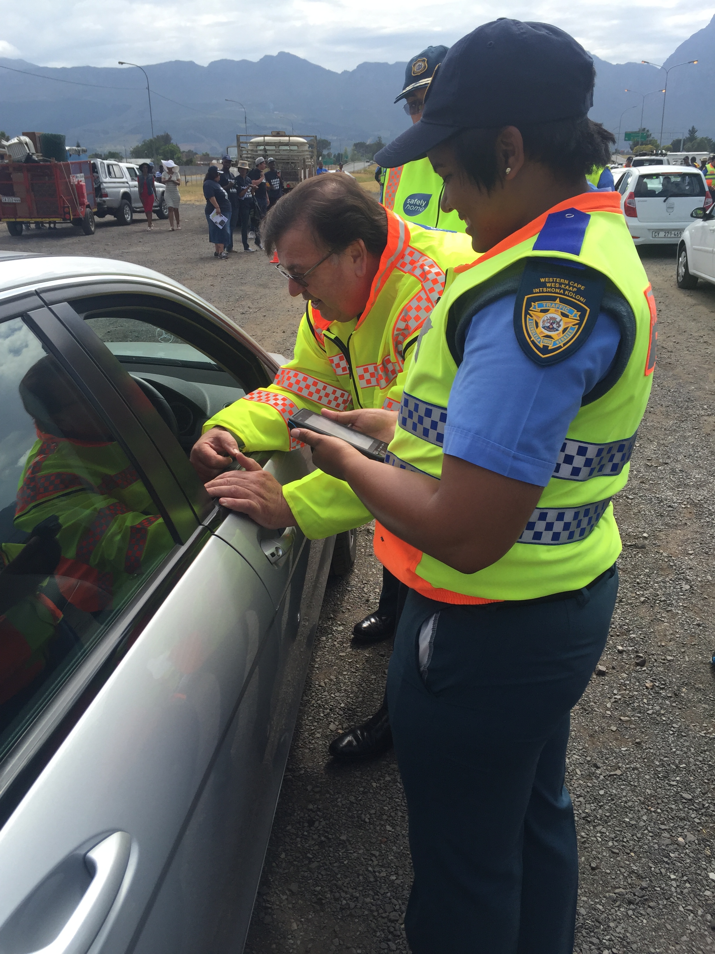 Minister Grant interacts with motorists at the roadblock ahead of the launch.