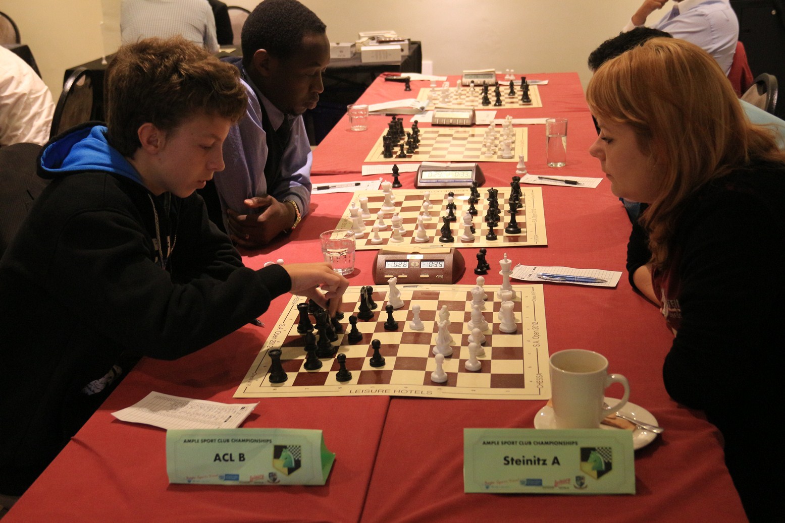 FIDE Master Daniel Barrish makes a move with Woman Grandmaster Katarzyna Toma keeping a close eye.
