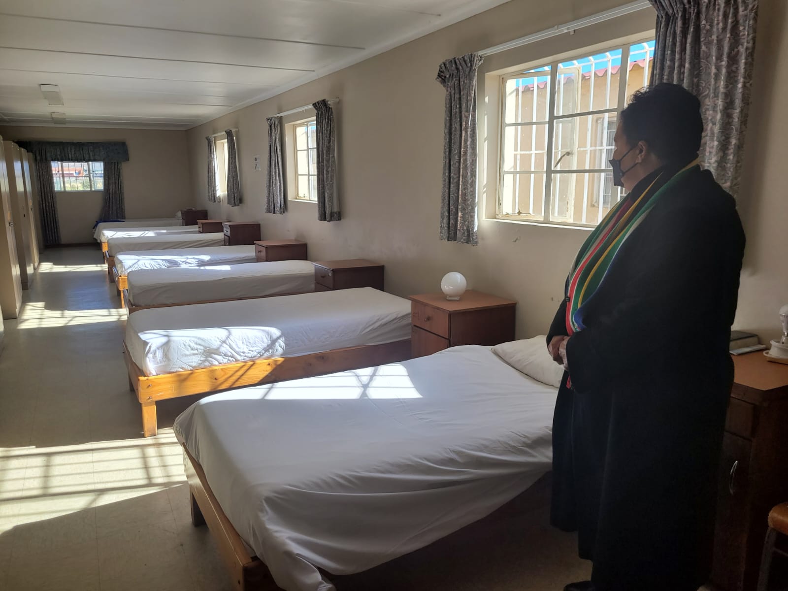 Minister Fernandez in one of the dorm rooms at Toevlug Centre