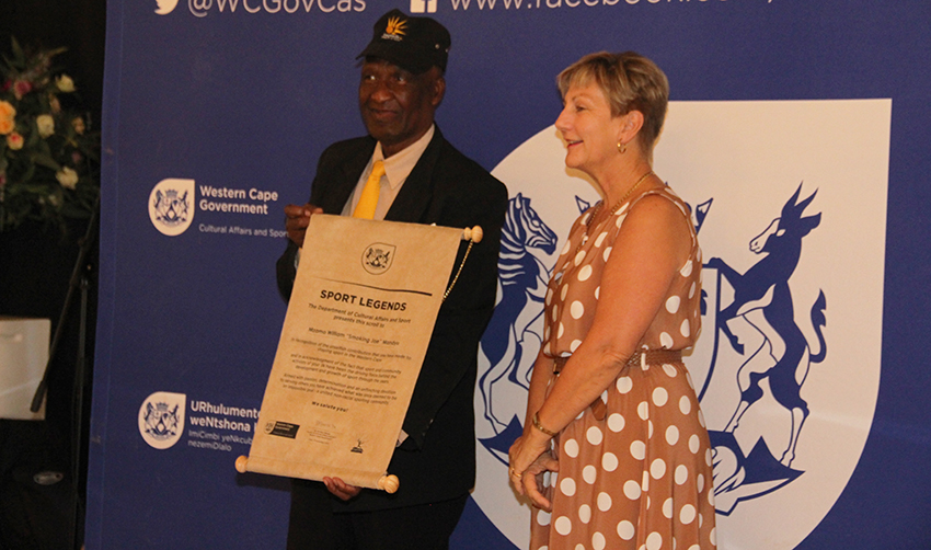 Legendary boxer and trainer, Mzamo “Smoking Joe” Mandyu, receives his cap and scroll from Minister Anroux Marais on Thursday.