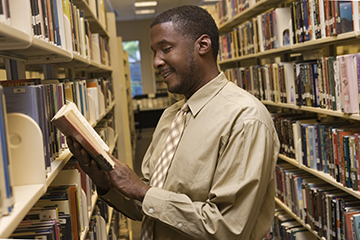 man in library adult literacy