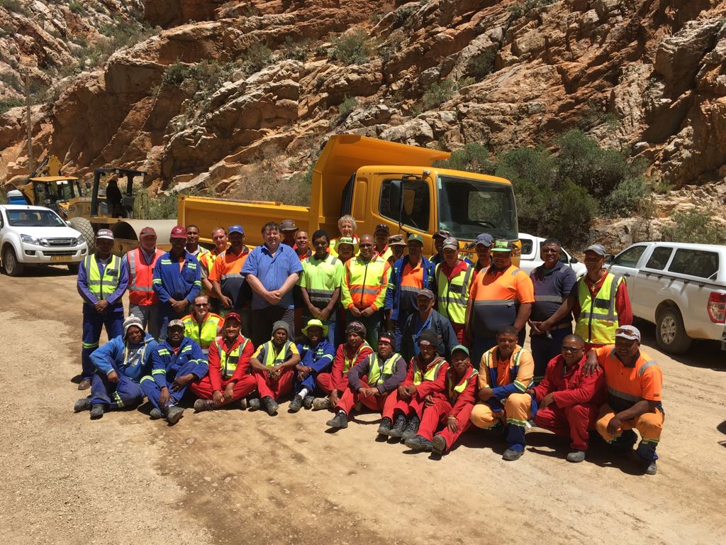 Minister Grant with workers during a recent visit to the Pass.