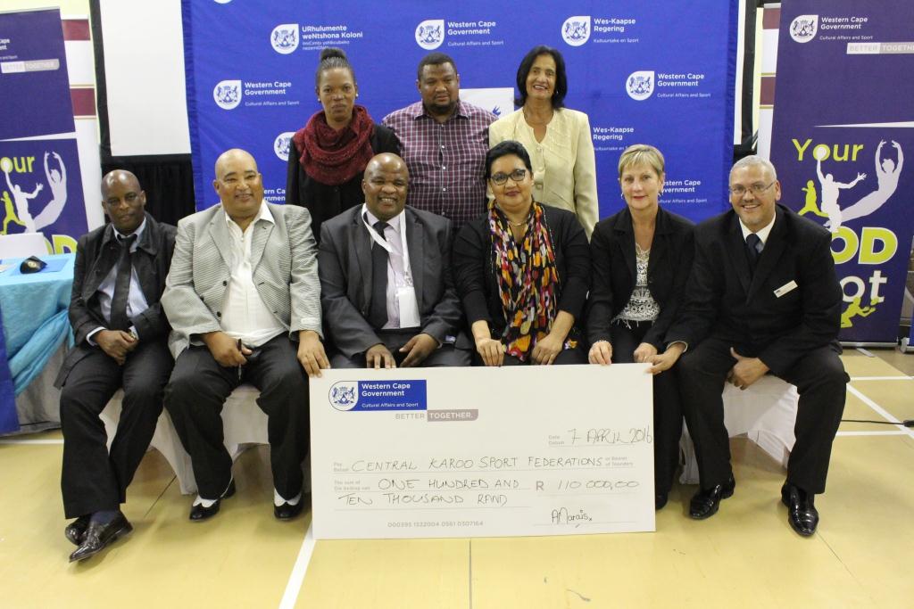Minister Marais with other DCAS officials and the recipients of the cheque of R110 000
