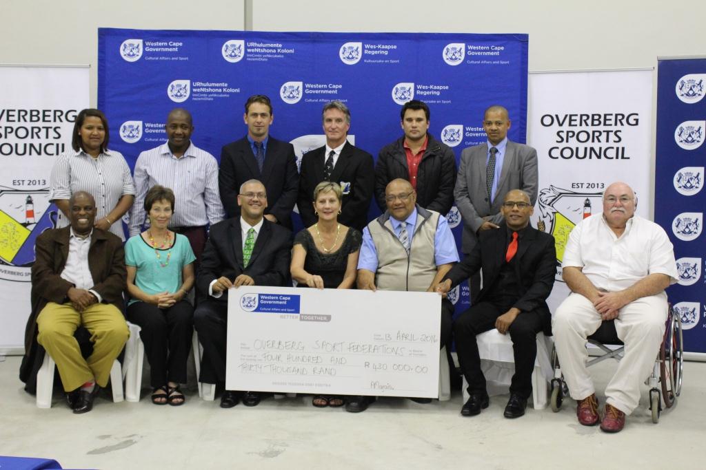Minister Marais with other DCAS officials and the recipients of the cheque of R430 000