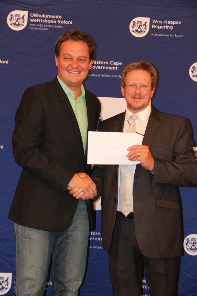 Minister Theuns Botha hands over a cheque to Albertus Kennedy from the local cricket board