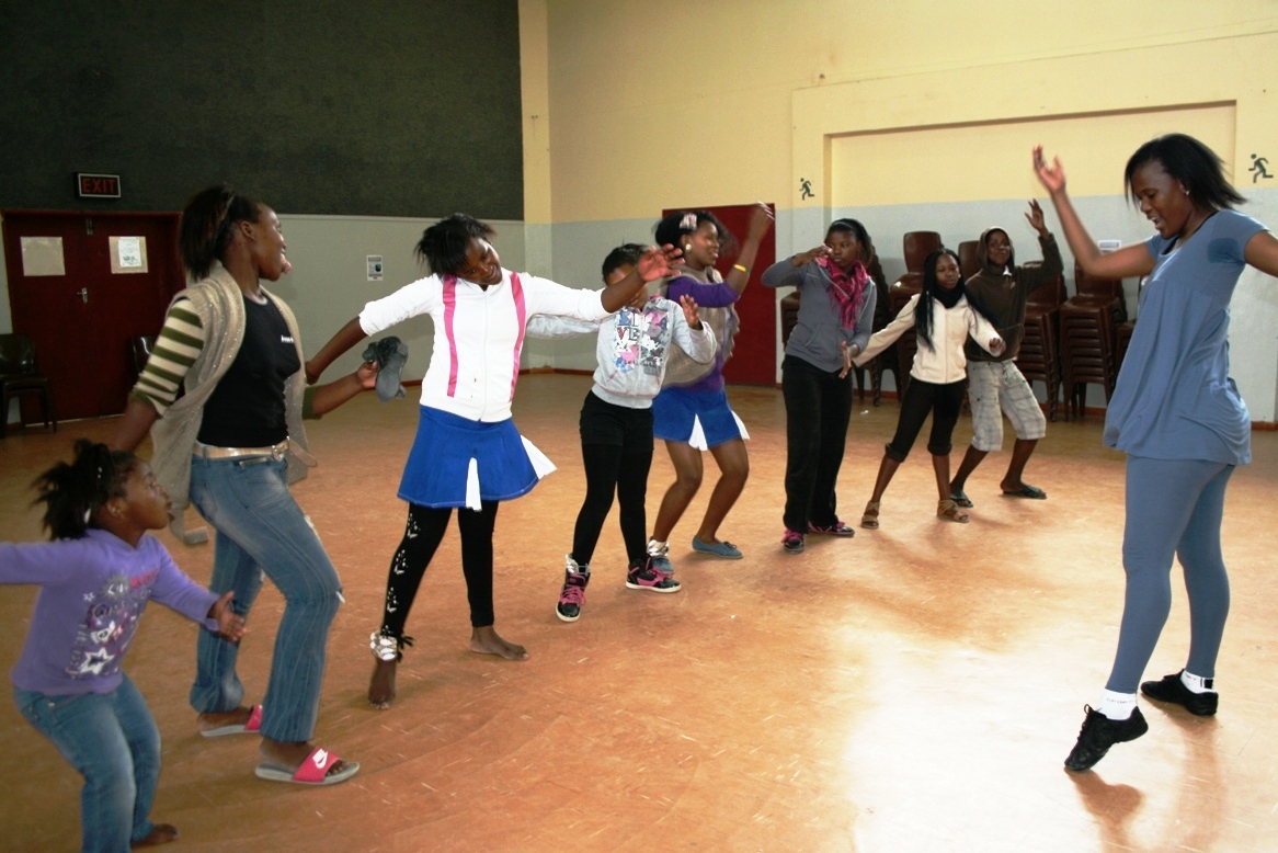 Nandipha Sandlana dancing with the female participants during a workshop.