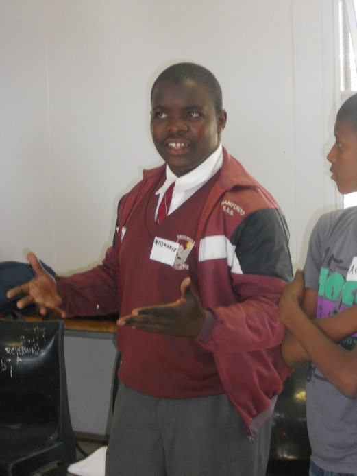 One of the learners performs praise singing during a workshop.