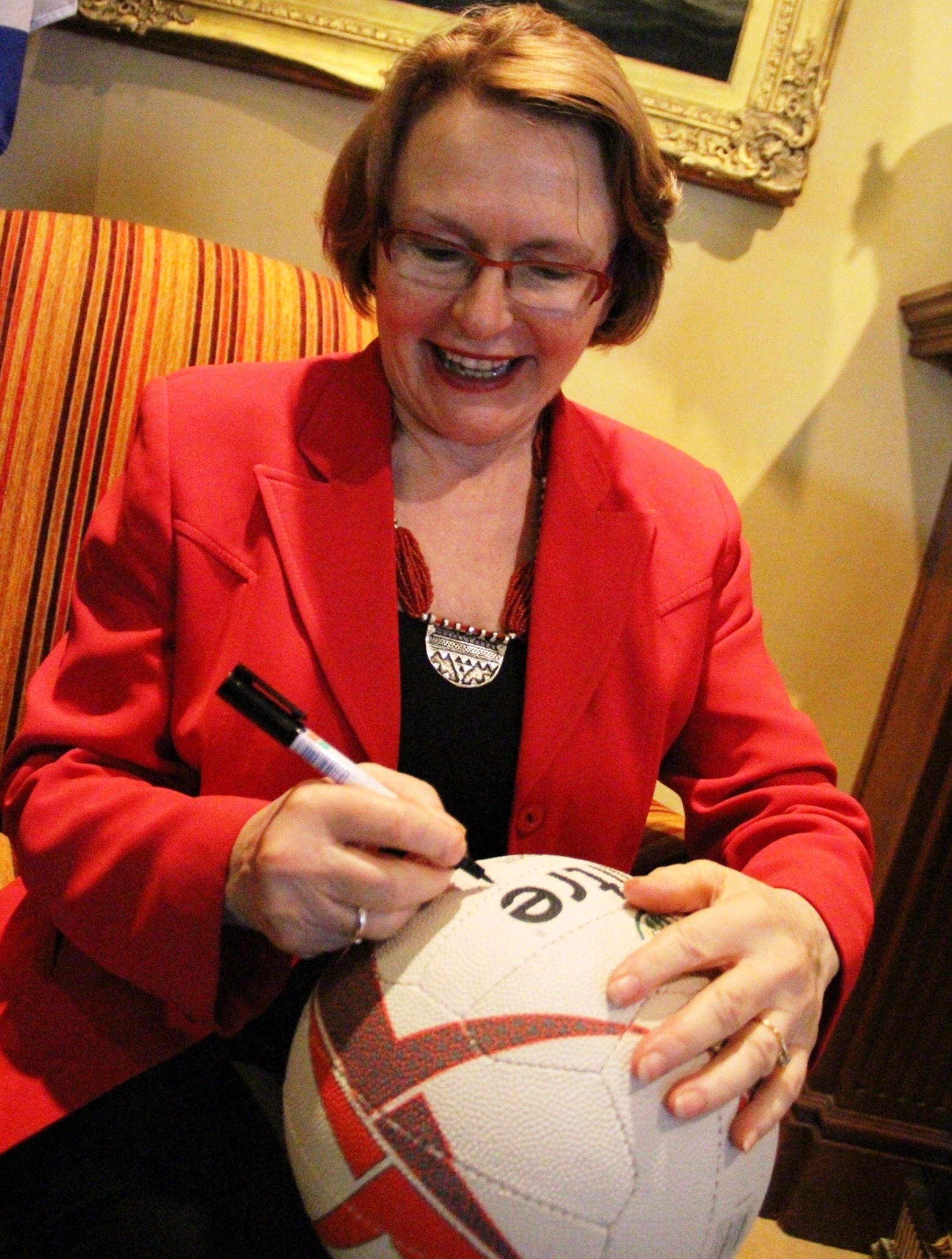 Premier Helen Zille signs a ball.