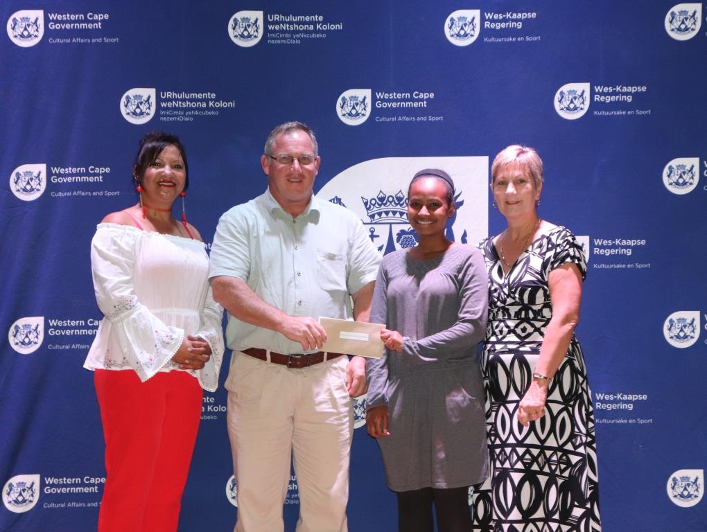 Representatives of the SWD Majorettes Association accepting the cheque from DCAS CFO Brenda Rutgers and Minister Anroux Marais
