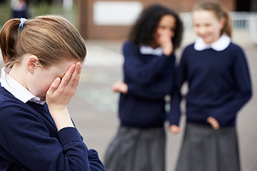 school girl being bullied by classmates 