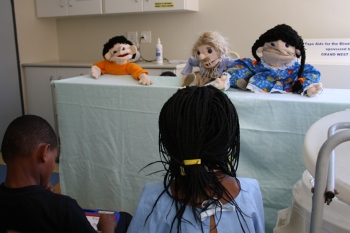  Occupational therapists host a puppet show in Ward D2 to teach children and their parents about the role OTs play.
