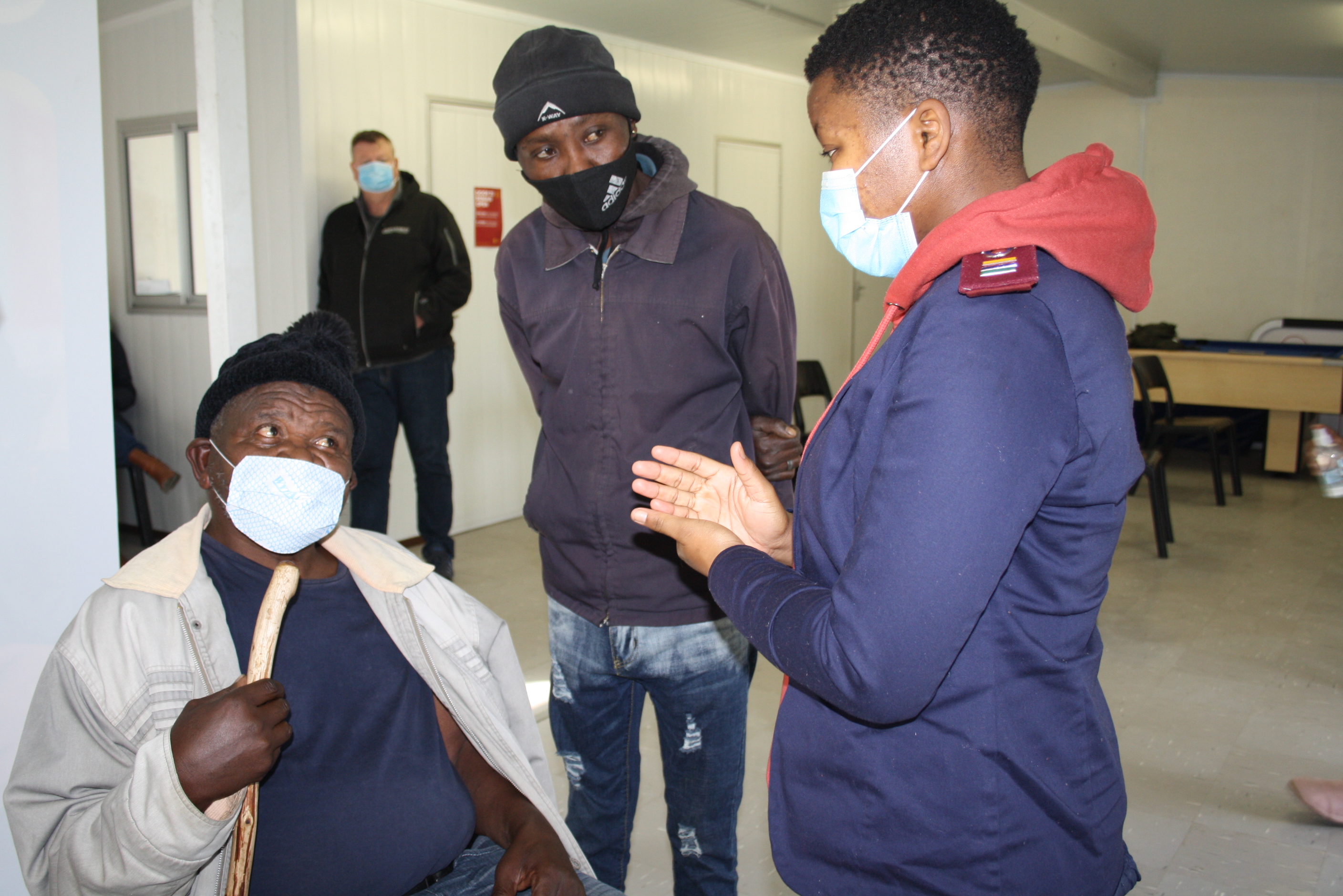 Sr Nandipha Mbundwine explains the process of vaccination to Mr Thobela Mdunyelwa,