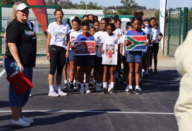 A group of Hopefield schoolgirls walk onto the brand new netball court for the first ever training session.