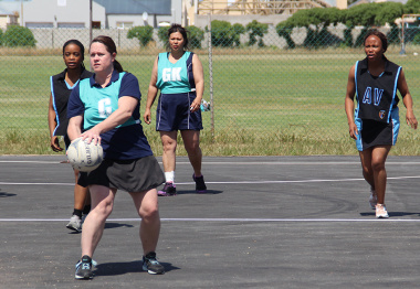 A netball player prepares to make a pass during one of the matches