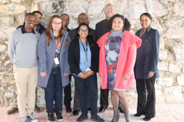Acting DCAS HOD Dr Bouah with Dr Dlamuka and the Heritage Team at one of the restored walls inside the Old Granary Complex