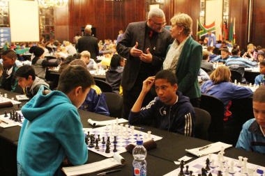 Adv. Lyndon Boauh of DCAS and Minister Marais observing young players at the SA Chess Open