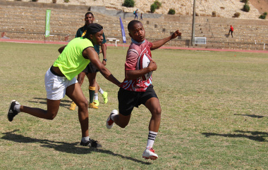 An SA Infantry School player cuts through a gap during a touch rugby game.