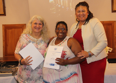Anita Joseph (centre) receives her certificate of participation from DCAS assistant director, Liezl Jansen (right), in Genadendal on Thursday