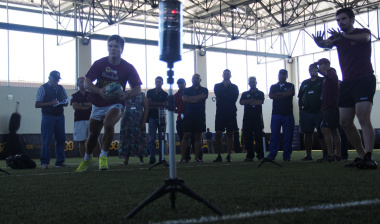 Athletes demonstrate the practical on Speed and Laser Technology, while participants look on.