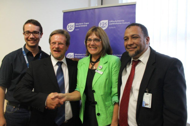 Two of the Champions of the C2AIR2 Club Challenge, Mr Donovan Hopkins (left), and Dr. Erma Mostert (second right) with Mr Theuns Botha, Western Cape Minister of Health (second left), and Dr Anwar Kharwa (CEO Khayelitsha Hospital).
