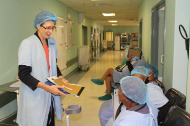 Dr Beth Engelbrecht, HOD for Western Cape Government Health assists patient with her folder at the eye clinic.