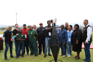 Chaney Willemse from Boland Cavaliers lights the Olympic Torch, as dignitaries from the Western Cape Sport Federation and Stellenbosch Municipality look on.