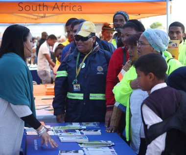 Members of the community listen as Ms Chantell Hendricks (left), of DOCS educates them on the various projects the Department. 