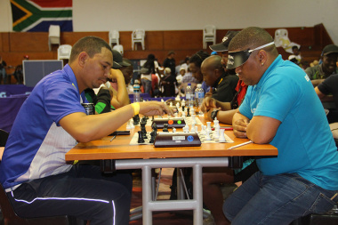 Chess players focus intently on their next move.