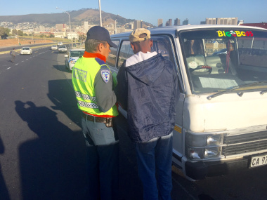 City of Cape Town traffic officer with driver of impounded vehicle.