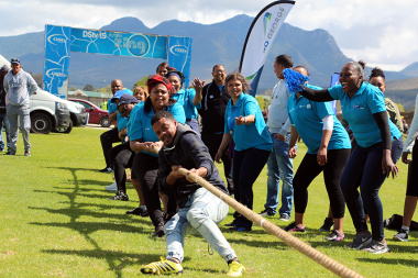 Colleagues cheering for Team Health at tug-of-war