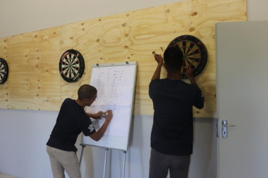 Eager competitors wrap up a dart game at the BTG Games in Caledon