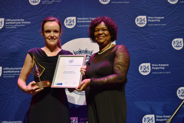 A representative from Africa Centre-Infecting the City accepting an award for Best Contribution to Visual Arts, including Public Arts from Jane Moleleki