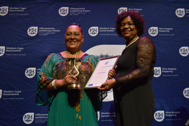 Abeedah Medell receiving her award from Jane Moleleki for Best Contribution to Performing Arts: Dance