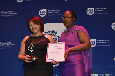 A representative from Adriaanse Public Library receiving an award for Best Medium Public Library from Nomaza Dingayo