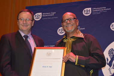 Minister Anton Bredell handing over a ministerial award to Elias P Nel