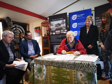 Denis Goldberg signs the co-operative agreement that will enable the establishment of a new education and training centre at the Hout Bay museum