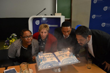 Director Nomaza Dingayo, Minister Anroux Marais, Minister of Finance Dr Ivan Meyer and HOD Walters blowing out the birthday candles