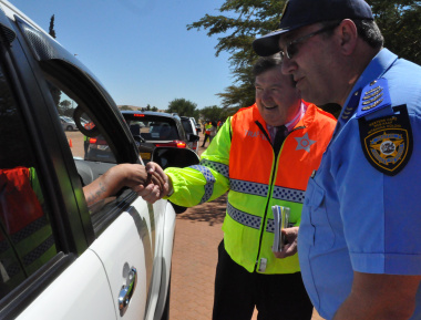 Minister Donald Grant and Vredenburg Traffic Chief Desmond Payton interact with a motorist.