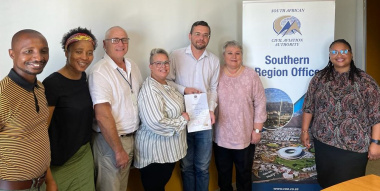 Dr Ilse Trautmann flanked by WCDoA and SACAA officials receiving the certificate from SACAAS Trudy Sebastiaan