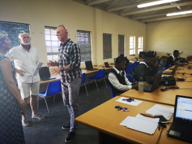 Education leader Trevor Snyman explains the programme to Minister Anroux Marais at Minister Anroux Marais and Coach Sipho Mthembu at the Kwano Cycling Academy at Murray High School in the Bitou Municipality